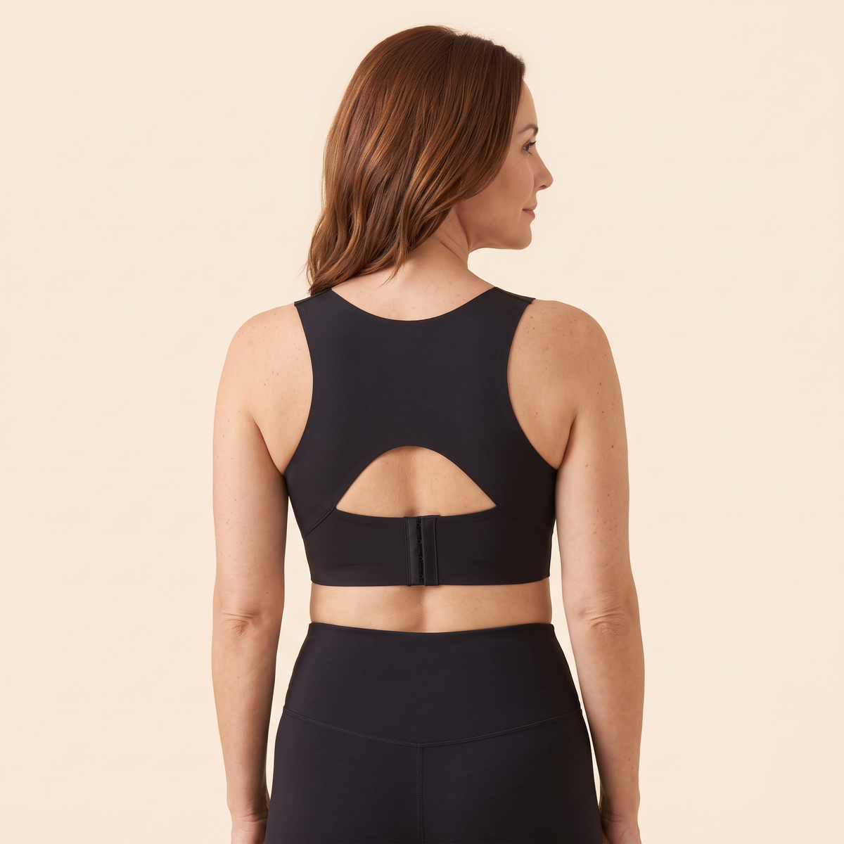 The X-back of the black Swanlift posture bra, worn